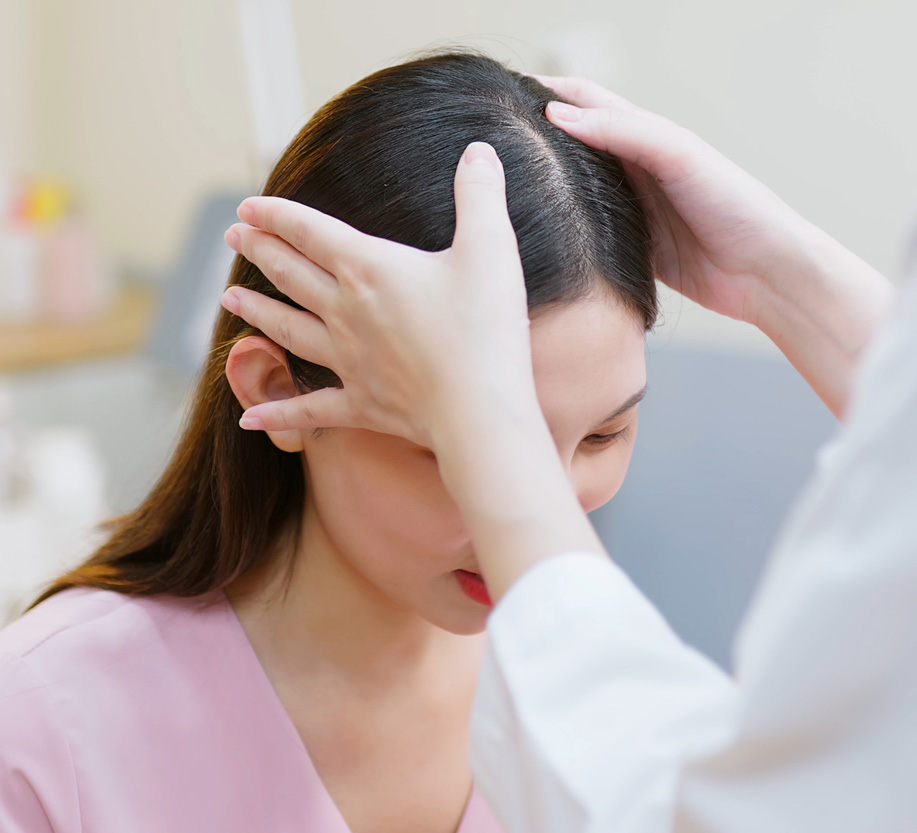 doctor looking at womans scalp